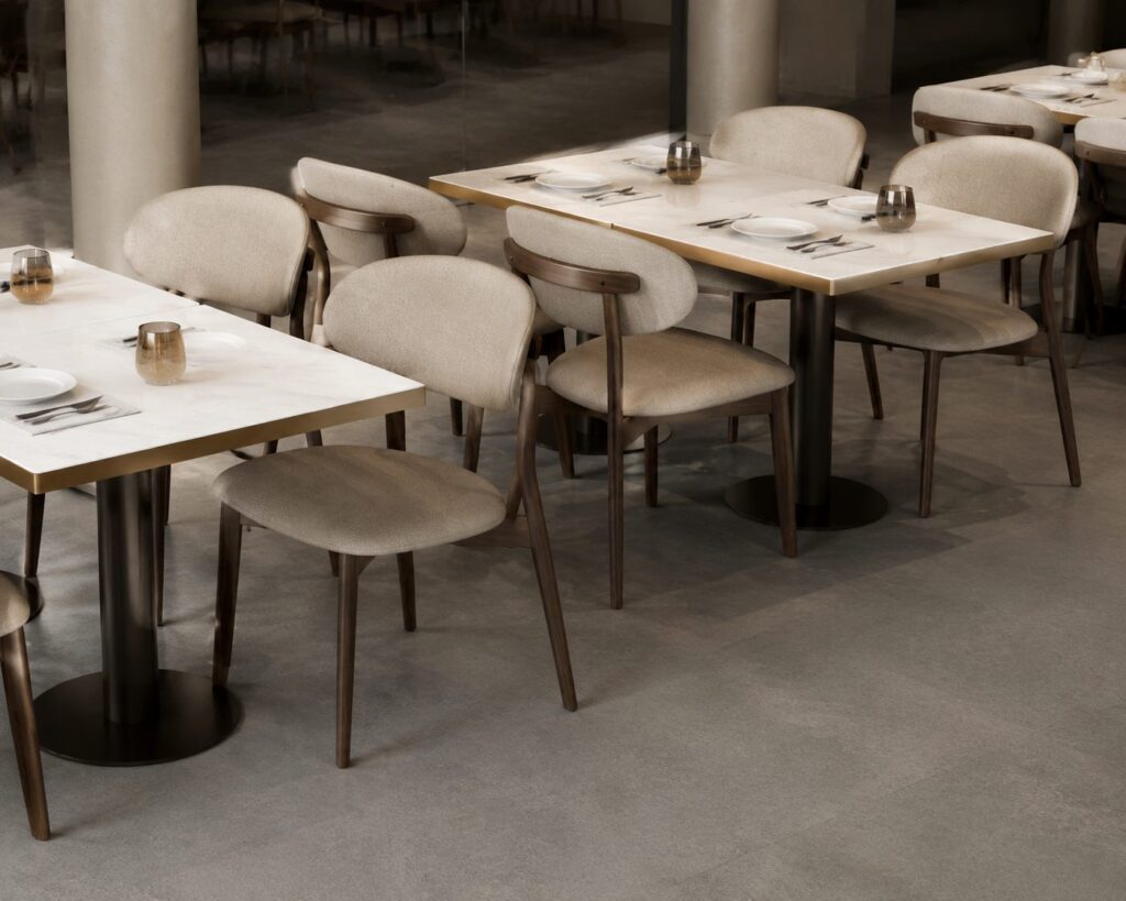 Minimalist café interior with marble tables and chairs.